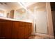 Bathroom features a shower and double vanity with wood cabinets at 9408 Forest Edge Ave, Las Vegas, NV 89149