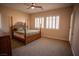 Spacious bedroom with a large bed, carpet flooring and window shutters at 9408 Forest Edge Ave, Las Vegas, NV 89149