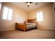 Well-lit bedroom with a wooden bed frame and ceiling fan at 9408 Forest Edge Ave, Las Vegas, NV 89149