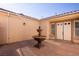 Charming courtyard entry with fountain and double doors at 9408 Forest Edge Ave, Las Vegas, NV 89149