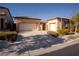 Two-car garage and attractive landscaping at 9408 Forest Edge Ave, Las Vegas, NV 89149