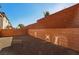 Landscaped backyard with a high brick wall offering privacy at 9875 Vista Meadows Ave, Las Vegas, NV 89148