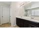 Double vanity bathroom with dark brown cabinets and a large mirror at 9875 Vista Meadows Ave, Las Vegas, NV 89148