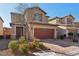 Two-story house with brown garage door and brick driveway at 9875 Vista Meadows Ave, Las Vegas, NV 89148