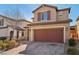 Two-story house with brown garage door and brick driveway at 9875 Vista Meadows Ave, Las Vegas, NV 89148