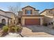 Two-story house with brown garage door and brick driveway at 9875 Vista Meadows Ave, Las Vegas, NV 89148