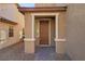 House exterior featuring a brown front door and brick walkway at 9875 Vista Meadows Ave, Las Vegas, NV 89148