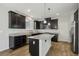 Modern kitchen with island, granite countertops, and stainless steel appliances at 9875 Vista Meadows Ave, Las Vegas, NV 89148