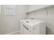 Convenient laundry room with washer, dryer, and shelving at 9875 Vista Meadows Ave, Las Vegas, NV 89148