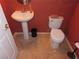 Clean bathroom with pedestal sink and toilet at 10046 Daybreak Dew Ct, Las Vegas, NV 89183