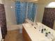 Bathroom with double vanity and blue shower curtain at 10046 Daybreak Dew Ct, Las Vegas, NV 89183