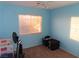 Small bedroom with light blue walls and carpeted floor at 10046 Daybreak Dew Ct, Las Vegas, NV 89183