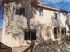 Two-story house with large windows and a patio, surrounded by trees at 10046 Daybreak Dew Ct, Las Vegas, NV 89183