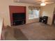 Living room with a large TV, window, and carpeted floors at 10046 Daybreak Dew Ct, Las Vegas, NV 89183