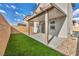 Artificial turf backyard with covered patio and gravel at 10211 Starlit Canyon Ct, Las Vegas, NV 89141