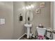 Powder room with pedestal sink and decorative mirror at 10211 Starlit Canyon Ct, Las Vegas, NV 89141