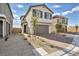 Two-story house with a gray garage door and landscaped yard at 10211 Starlit Canyon Ct, Las Vegas, NV 89141