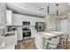 Modern kitchen with white cabinets, stainless steel appliances, and an island at 10211 Starlit Canyon Ct, Las Vegas, NV 89141