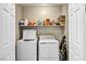 Laundry closet with washer, dryer and shelving for storage at 10211 Starlit Canyon Ct, Las Vegas, NV 89141