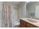 Bathroom featuring tile shower and tub combo, and dark wood vanity at 1073 Silver Bullet Ct, Henderson, NV 89011