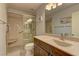 Bathroom featuring walk in shower with glass door, granite counters, and modern fixtures at 1073 Silver Bullet Ct, Henderson, NV 89011