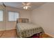 Cozy bedroom featuring new bed and comforter set, hardwood floors, and ceiling fan at 1073 Silver Bullet Ct, Henderson, NV 89011