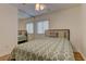 Cozy bedroom featuring new bed and comforter set, hardwood floors, and ceiling fan at 1073 Silver Bullet Ct, Henderson, NV 89011