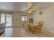 Bright dining area with tile flooring, wood table and chairs, ceiling fan, and sliding door to the backyard at 1073 Silver Bullet Ct, Henderson, NV 89011