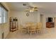 Open-concept dining area featuring tile flooring, wood table and chairs, a ceiling fan, and neutral wall color at 1073 Silver Bullet Ct, Henderson, NV 89011