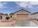 Charming single-story home featuring a terra cotta tile roof, desert landscaping, and an attached two-car garage at 1073 Silver Bullet Ct, Henderson, NV 89011