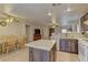 Open kitchen featuring granite counters, island, stainless steel appliances and adjacent dining area at 1073 Silver Bullet Ct, Henderson, NV 89011