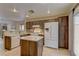 Open kitchen with stainless steel appliances, tiled backsplash, and adjacent breakfast bar at 1073 Silver Bullet Ct, Henderson, NV 89011