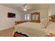 Spacious main bedroom with hardwood floors, large bed and dresser and ceiling fan at 1073 Silver Bullet Ct, Henderson, NV 89011