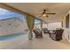 Relaxing covered patio area featuring comfortable seating and view of the private pool at 1073 Silver Bullet Ct, Henderson, NV 89011