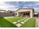 Artificial turf backyard with stone patio and seating area at 11671 Hatchling Ave, Las Vegas, NV 89138