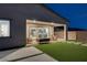 Night view of covered patio, artificial turf, and seating area at 11671 Hatchling Ave, Las Vegas, NV 89138