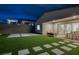 Night view of backyard with artificial turf and patio at 11671 Hatchling Ave, Las Vegas, NV 89138