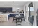 Modern kitchen with dark blue cabinetry, white countertops, and breakfast bar at 11671 Hatchling Ave, Las Vegas, NV 89138