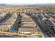 An aerial view of a desert community featuring single-Gathering homes with pools and picturesque mountain views at 11900 Star Grass Ave, Las Vegas, NV 89138