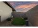 Cozy backyard featuring gravel, artificial turf, and surrounding brick wall at 11900 Star Grass Ave, Las Vegas, NV 89138