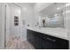 Sleek bathroom with double sinks, granite countertops, large mirror and modern fixtures at 11900 Star Grass Ave, Las Vegas, NV 89138