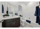 Modern bathroom featuring a dark vanity, undermount sink, and shower over tub at 11900 Star Grass Ave, Las Vegas, NV 89138