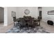 Dining room featuring a large wooden table with seating for six on a patterned rug at 11900 Star Grass Ave, Las Vegas, NV 89138