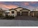 Home exterior featuring a two-car garage, decorative lighting, low-water landscaping and a concrete driveway at 11900 Star Grass Ave, Las Vegas, NV 89138