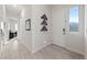 Bright foyer with tile floors, a front door, and a view into a home office at 11900 Star Grass Ave, Las Vegas, NV 89138