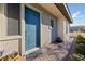 Charming front entry featuring a stylish blue door, brick walkway, and manicured landscaping at 11900 Star Grass Ave, Las Vegas, NV 89138