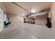 Spacious garage featuring epoxy floors, storage shelves, and ample workspace at 11900 Star Grass Ave, Las Vegas, NV 89138