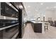 Spacious kitchen with stainless steel appliances, and an island that opens into a dining and living area at 11900 Star Grass Ave, Las Vegas, NV 89138