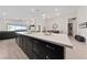 Modern kitchen featuring an island with dark cabinets, ample counter space, and stylish pendant lighting at 11900 Star Grass Ave, Las Vegas, NV 89138