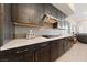 Modern kitchen with dark cabinets, stainless steel appliances, sleek countertops, and a modern backsplash at 11900 Star Grass Ave, Las Vegas, NV 89138